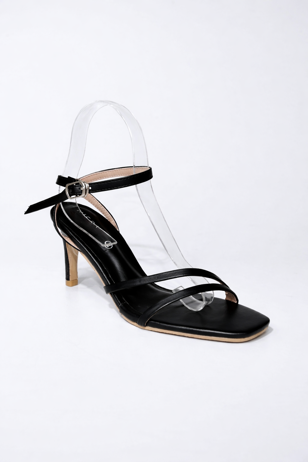 Black sandal with thin straps on a white background