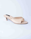 Beige high-heeled sandal on a light blue background
