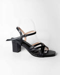 Black sandal with a block heel on a white background