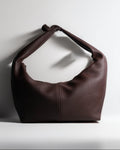 Brown leather handbag on a white background
