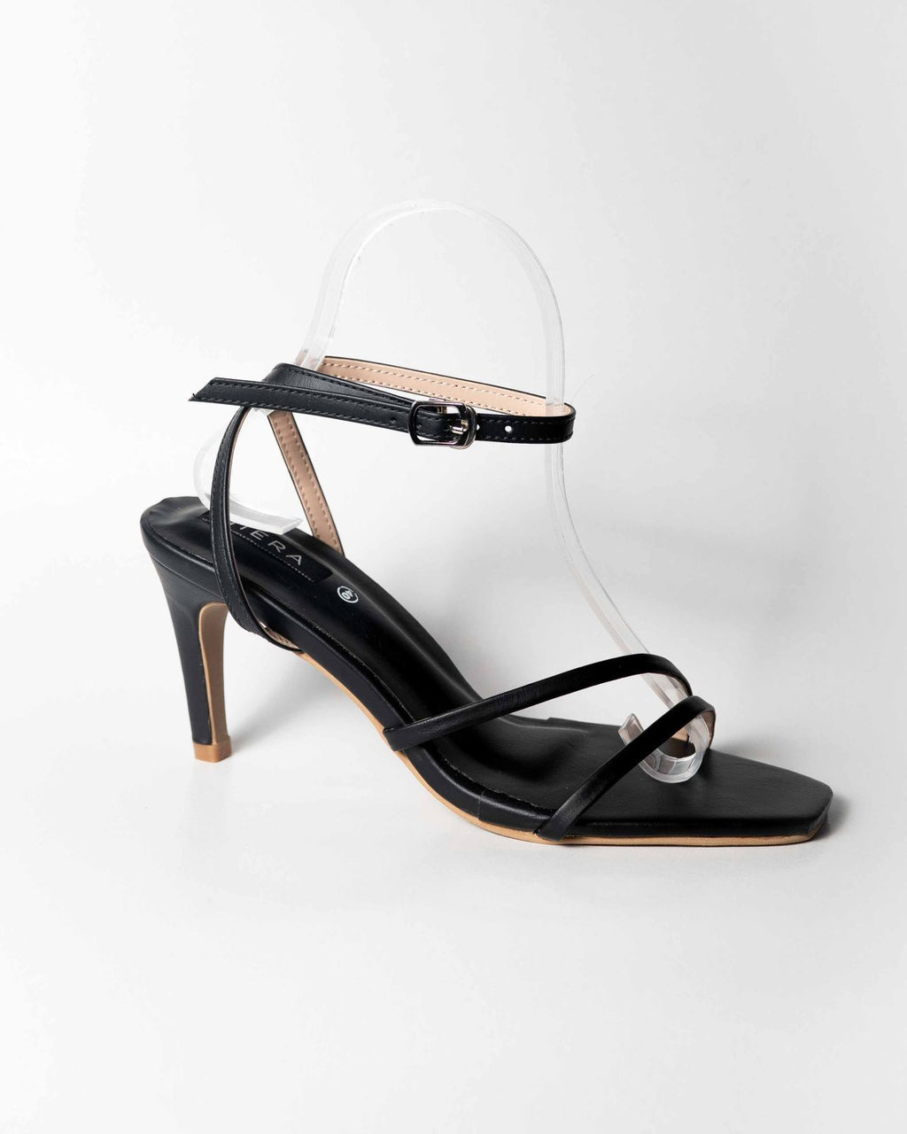 Black high-heeled sandal with thin straps on a white background