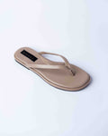 Beige sandal with a brand label on a light gray background